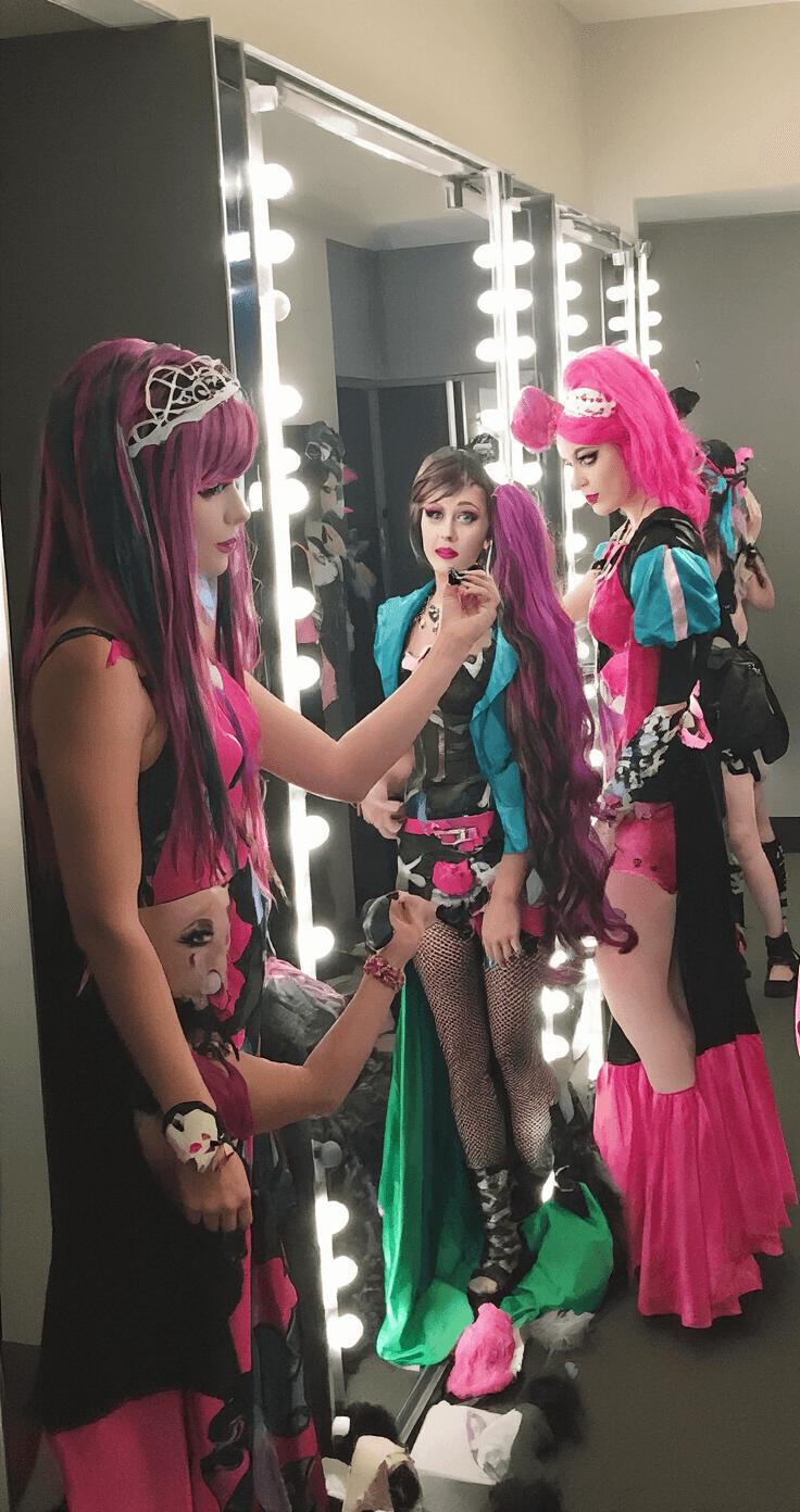 Monster High Cosplay: Create Scary-Cute Character Looks That Slay A vibrant dressing room filled with Monster High cosplayers making final adjustments to their costumes and makeup, with full-length mirrors reflecting their collaborative efforts under mixed lighting.