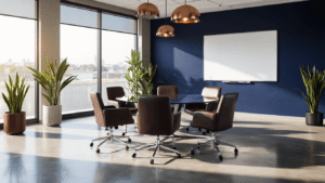 Sophisticated mini convention room featuring a round glass table surrounded by ergonomic charcoal chairs, navy accent wall, polished concrete floors, and warm lighting, creating a productive atmosphere.