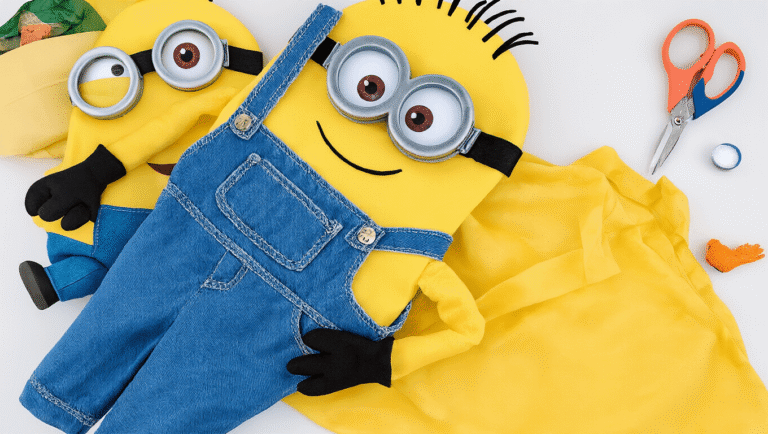 A minion costume made from yellow fabric, featuring blue overalls and black goggles, surrounded by crafting supplies on a clean background.