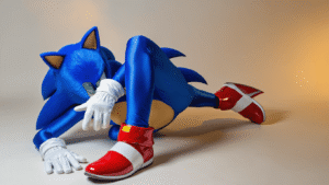 Sonic the Hedgehog cosplay with electric blue bodysuit, glossy red shoes, and white gloves on a clean white background, enhanced by warm golden lighting.